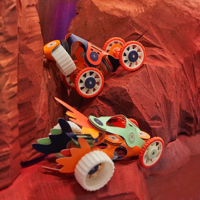 Toy car with orange wheels on a red textured surface