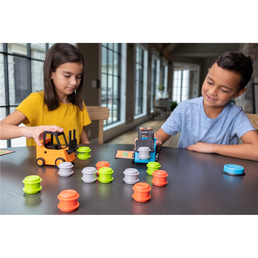 Two children playing with toy vehicles and colorful cylindrical objects on a table.