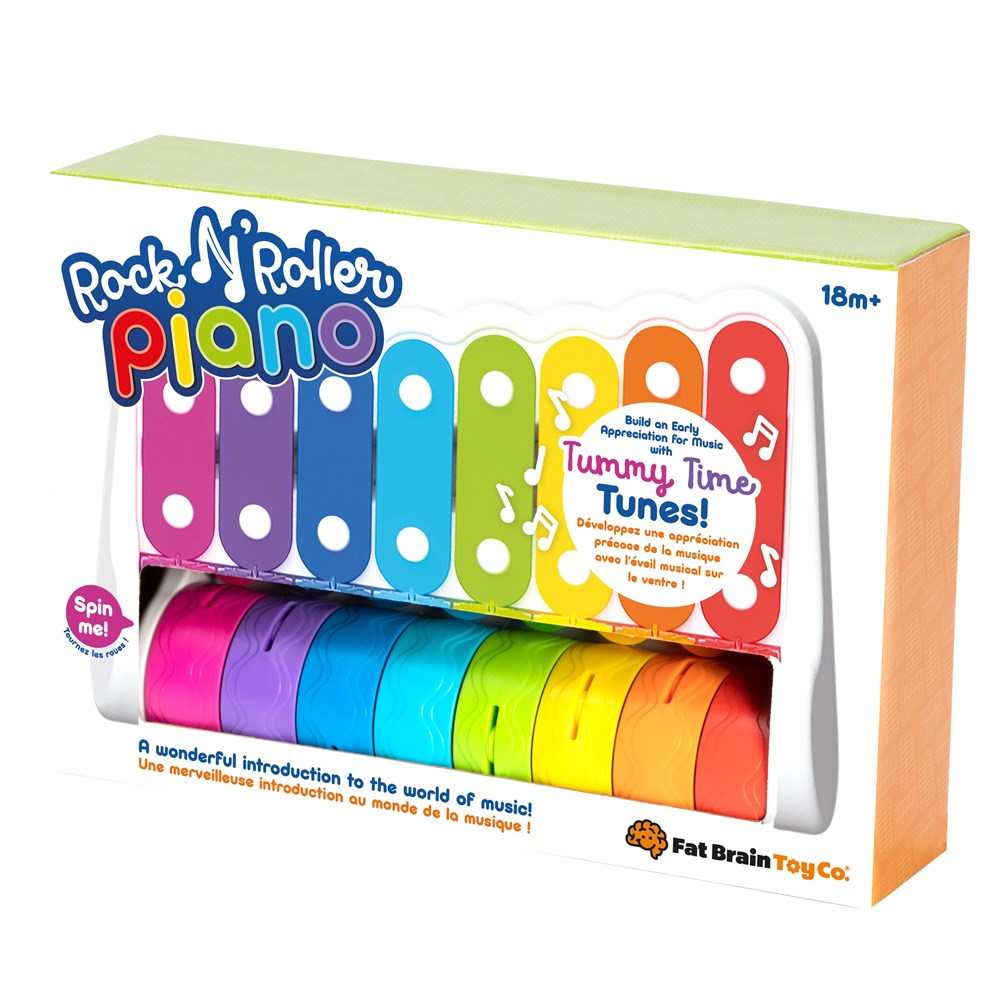 A colorful Rock 'n Roller Piano toy with multiple rolling wheels and a mallet, packaged in a box.