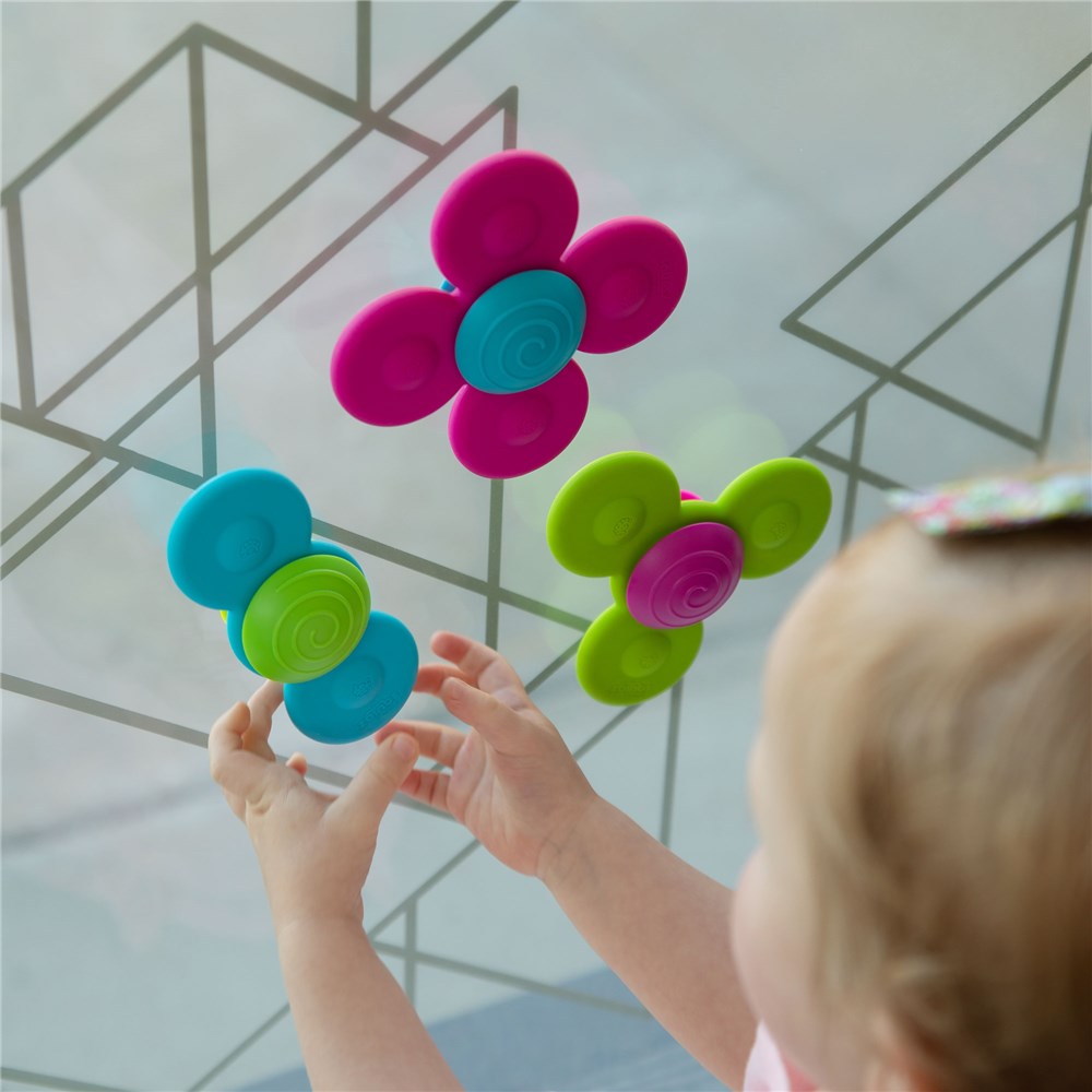 Child playing with Fat Brain Toys - Whirly Squigz