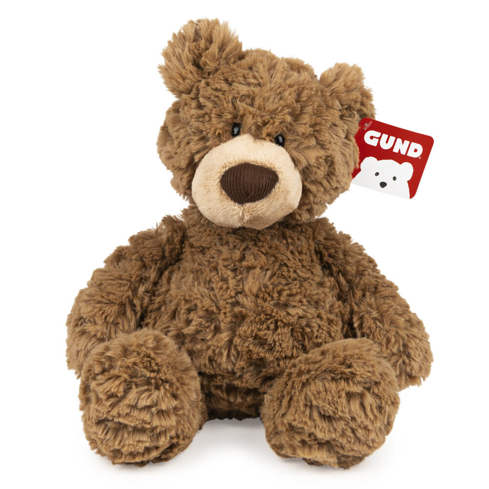 Brown teddy bear with a GUND tag on a white background