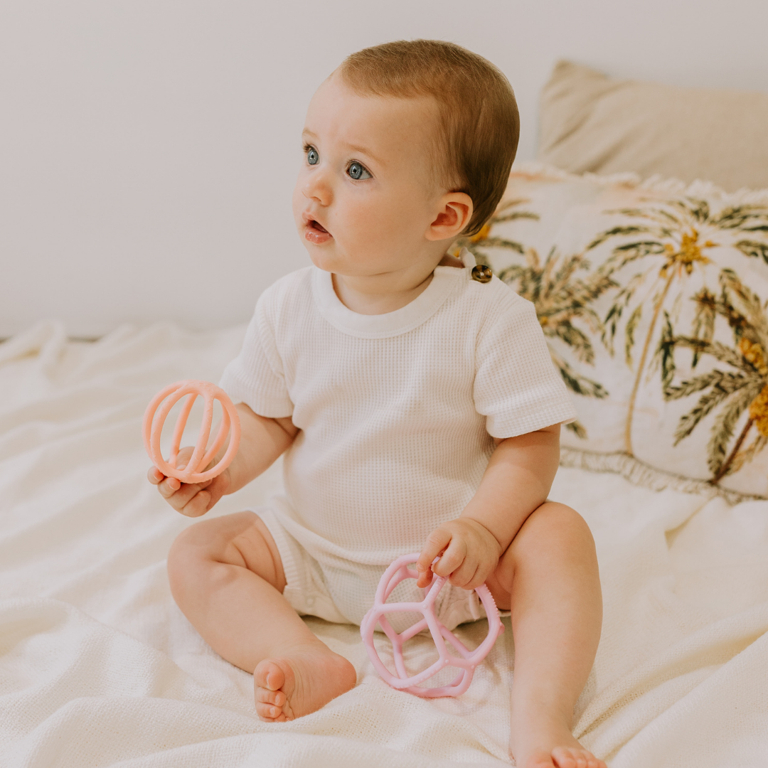 Baby holding Jellystone Designs - 2 Pack Sensory Ball