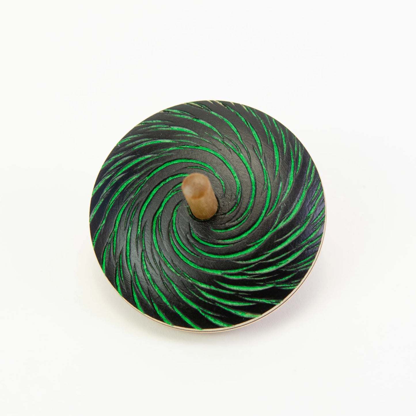 Spinning top with green and black spiral pattern on a white background