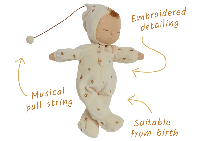 Baby doll in a white outfit with star patterns, featuring embroidered detailing and a musical pull string, suitable from birth.