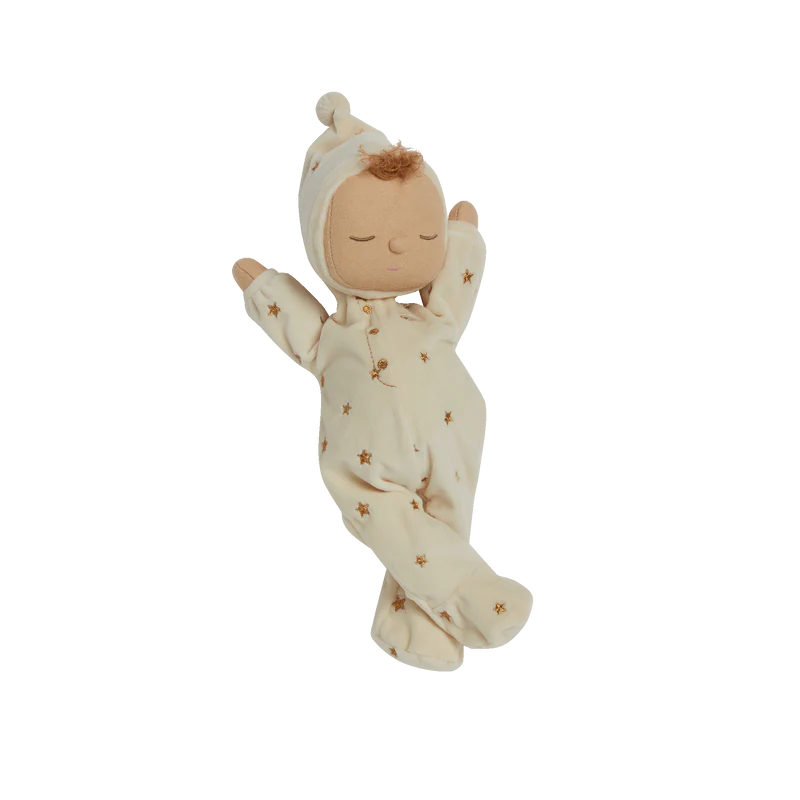 Baby doll in a cream outfit with star patterns on a white background