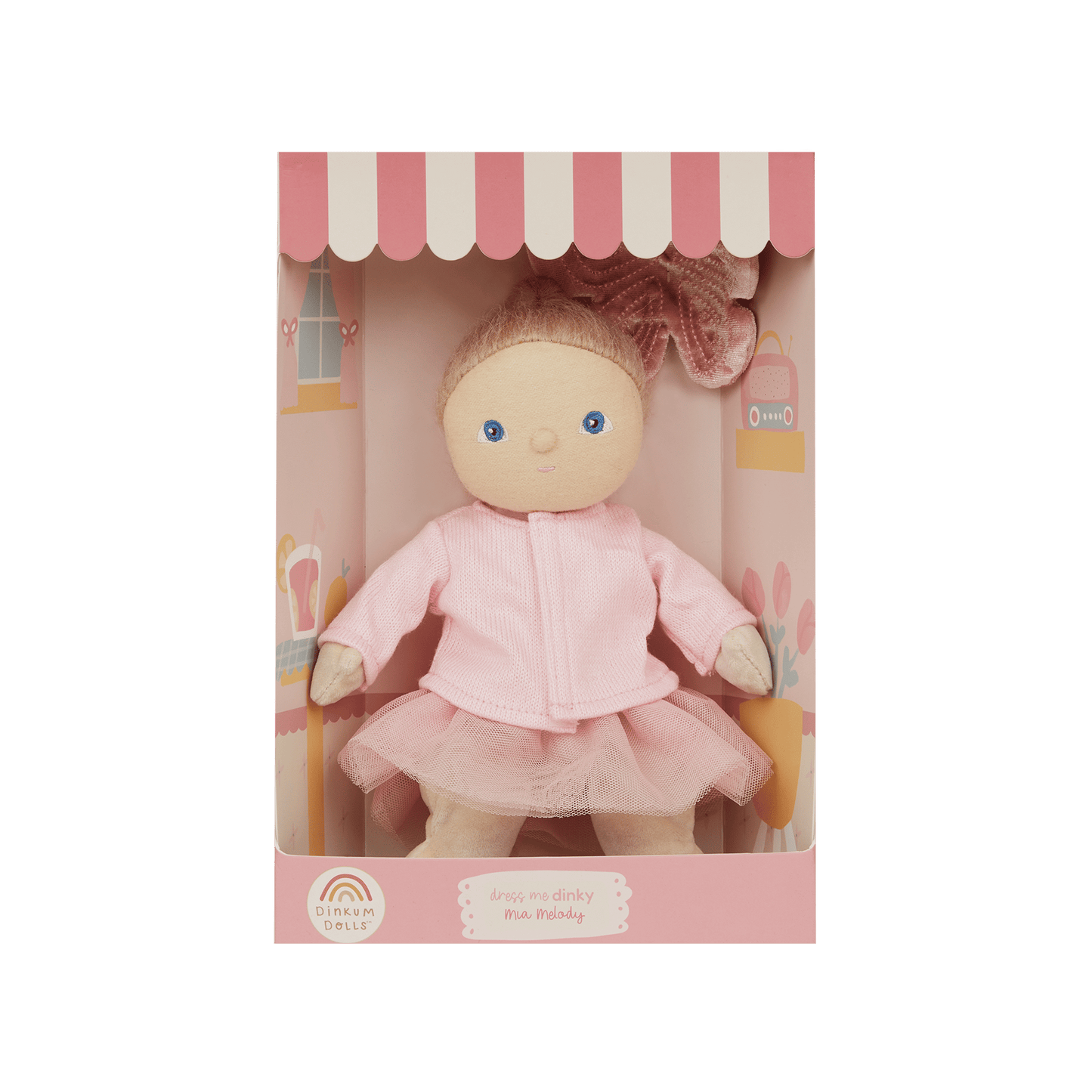 Doll in a pink outfit with a matching box on a green background