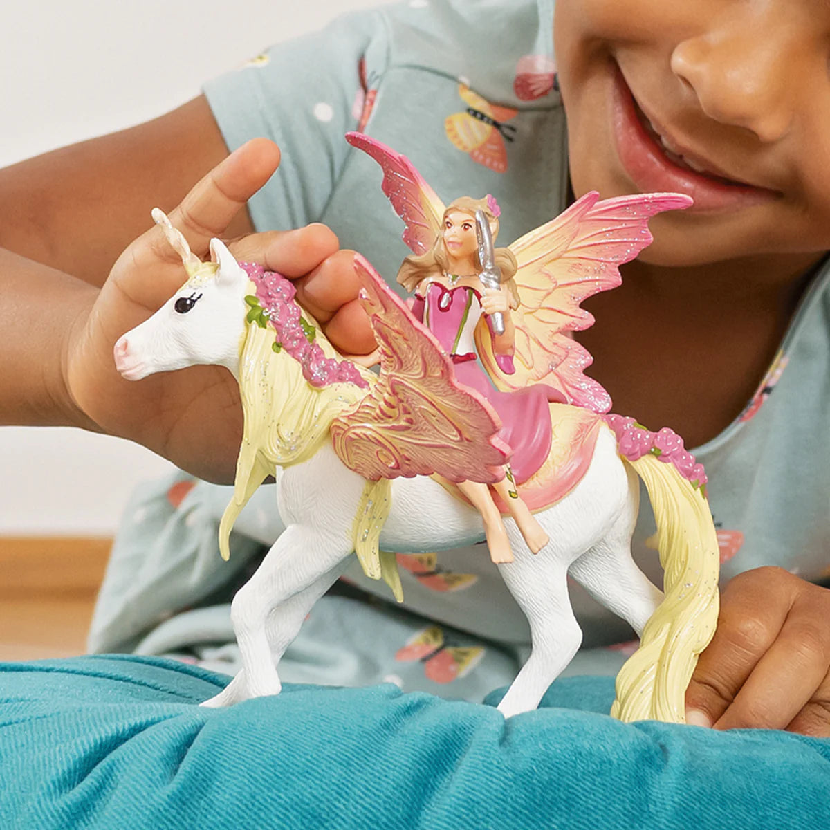 Child playing with a fairy and unicorn toy set