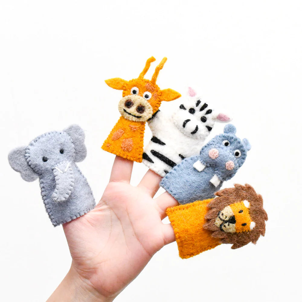 Set of animal finger puppets on a person's hand against a white background