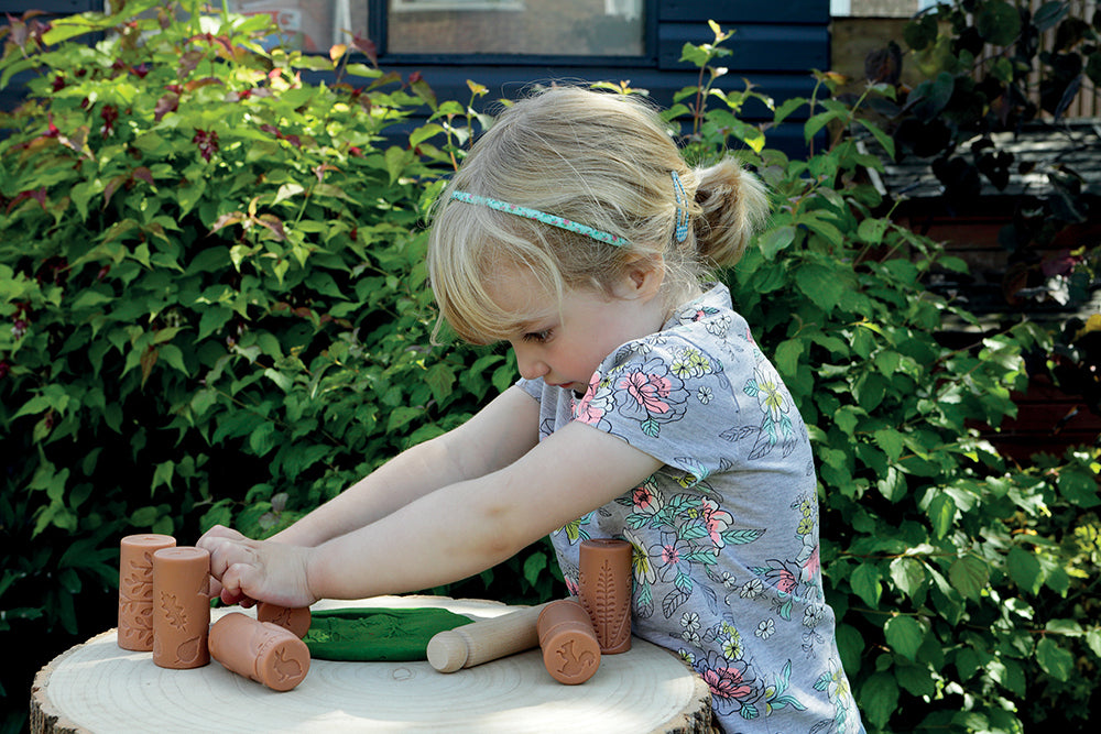 Child playing with wooden toys outdoors