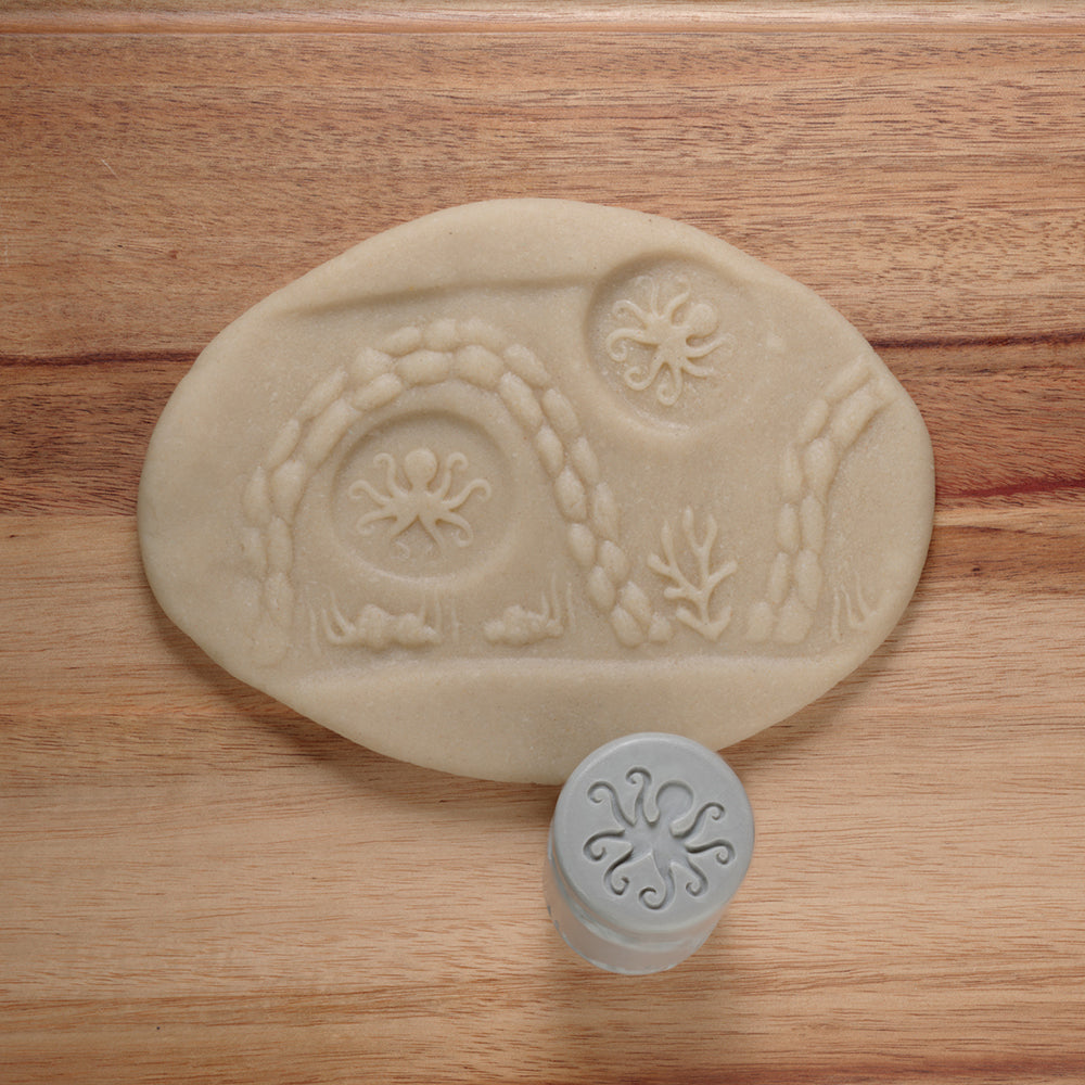 Oval-shaped soap with embossed design on a wooden surface
