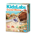 Box of KidzLabs Crystal Mining kit with magnifying glass, crystals, and tools on a white background