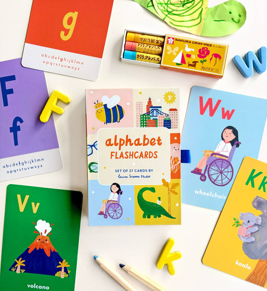 A collection of colorful illustrated flash cards for children learning the alphabet, displayed on a white background with a few cards showing double-sided letters and illustrations.
