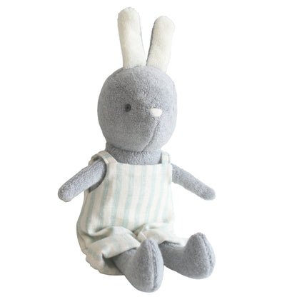 Plush toy rabbit in a white outfit with sage stripes on a white background