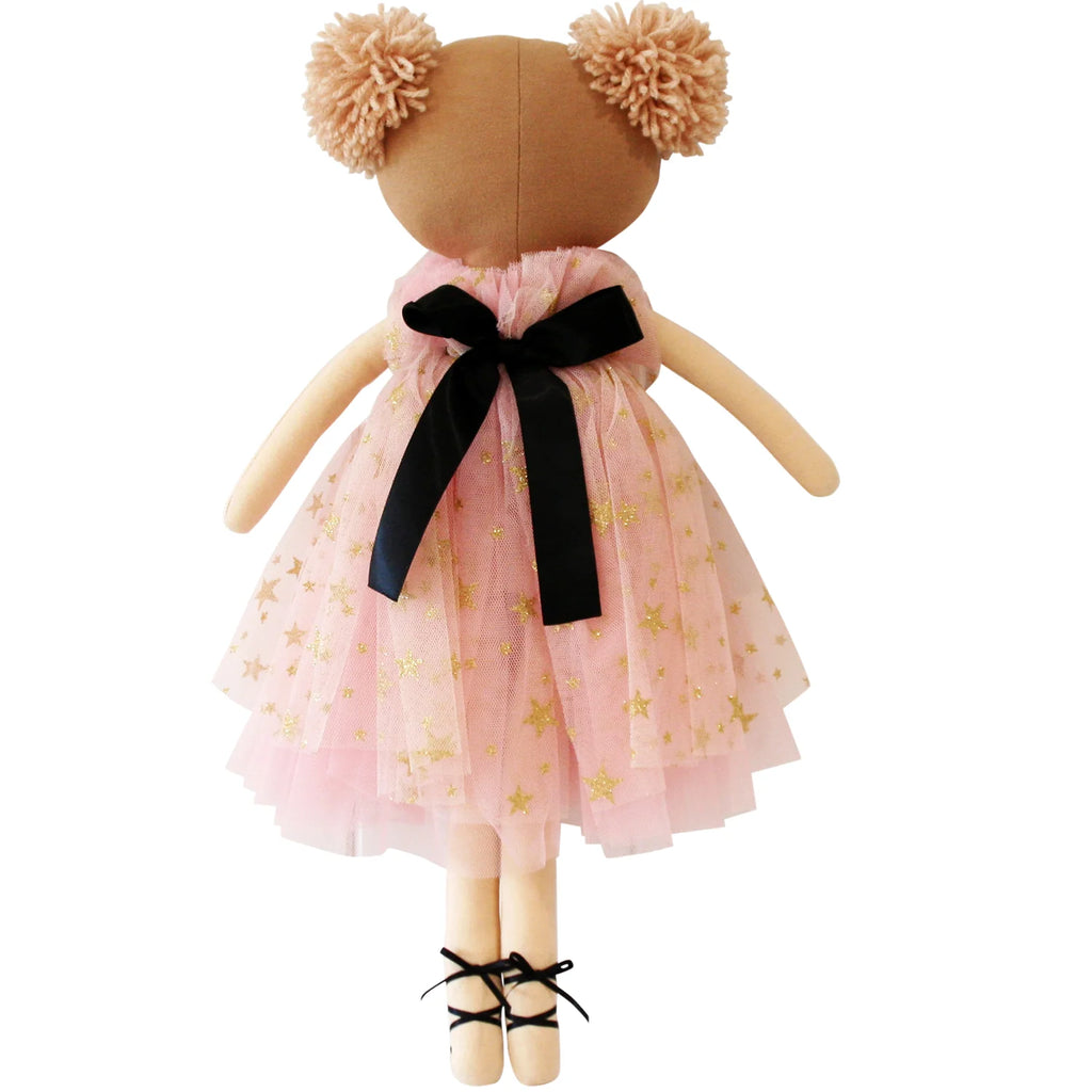 Stuffed toy doll wearing a pink dress with gold stars and a black bow on a white background