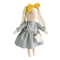 Stuffed toy rabbit with a yellow bow and gray dress on a white background