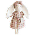 A plush toy rabbit dressed in a pink checkered dress with a removable bow, resembling a crossbody bag, and featuring a linen/cotton body.