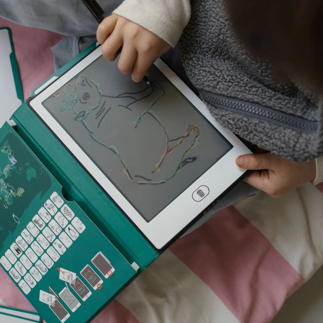 Child drawing on a small electronic device with a teal casing.