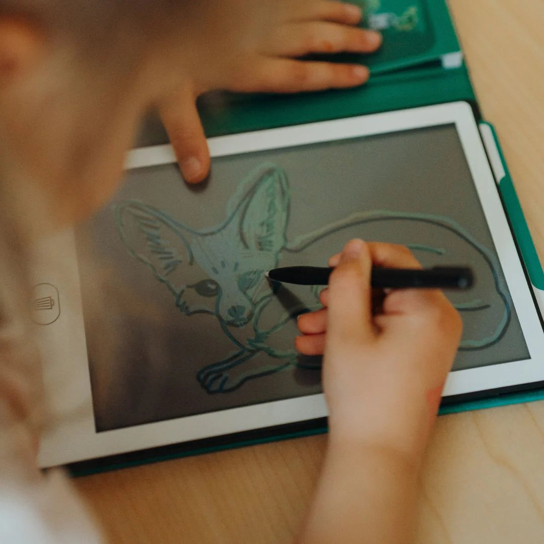 Person drawing a fennec fox on a digital drawing board with a stylus.