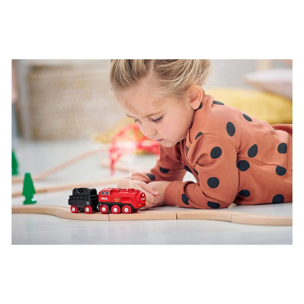 Child playing with BRIO - Steaming Train Set