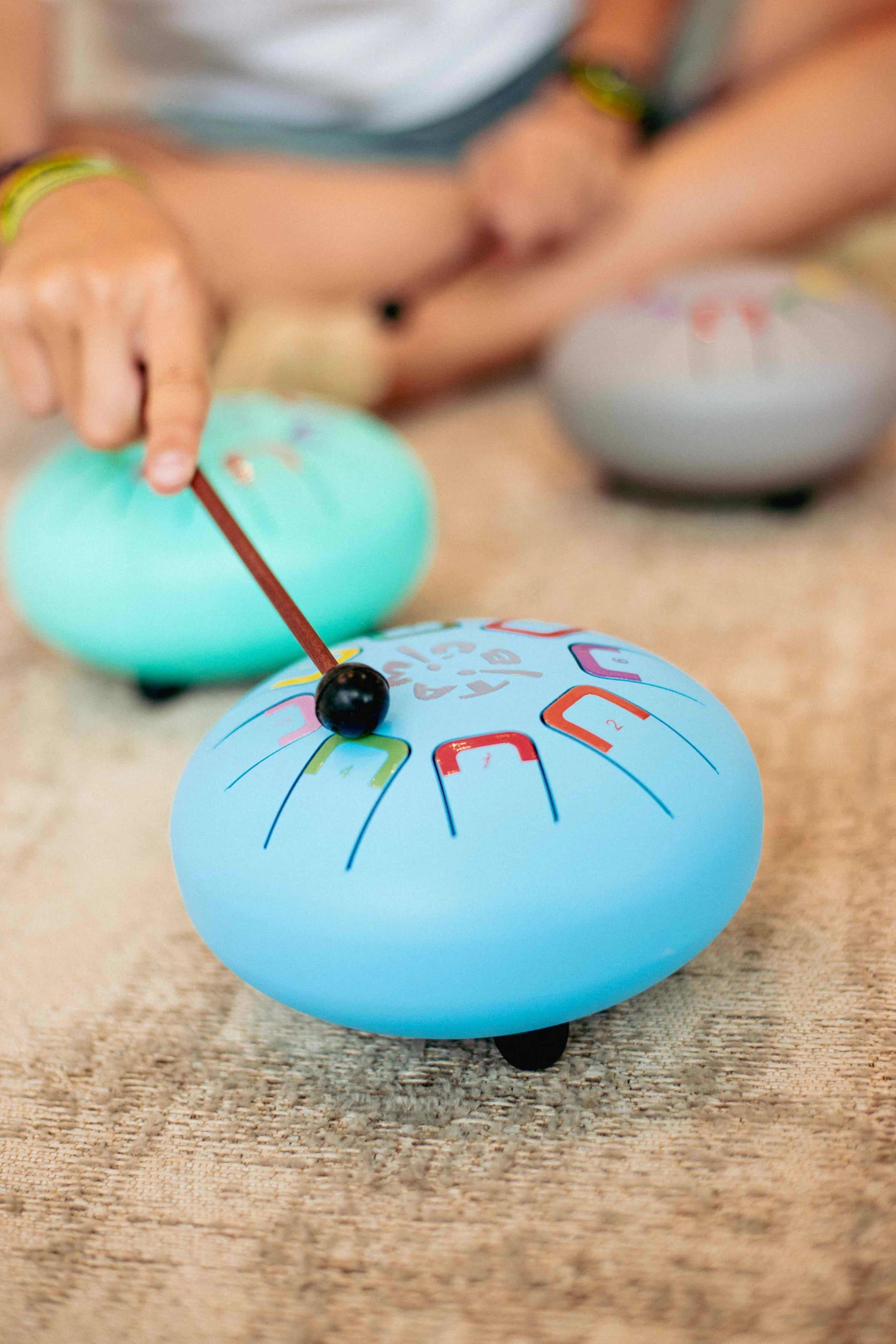 Children playing with colorful wooden toys on a wooden surface