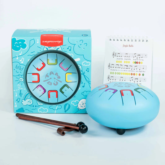 Blue jingle bell with music notes, packaging, and sheet music on a white background