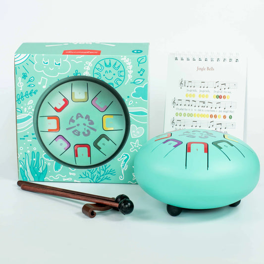 Turquoise children's musical instrument set with packaging and sheet music on a light blue background