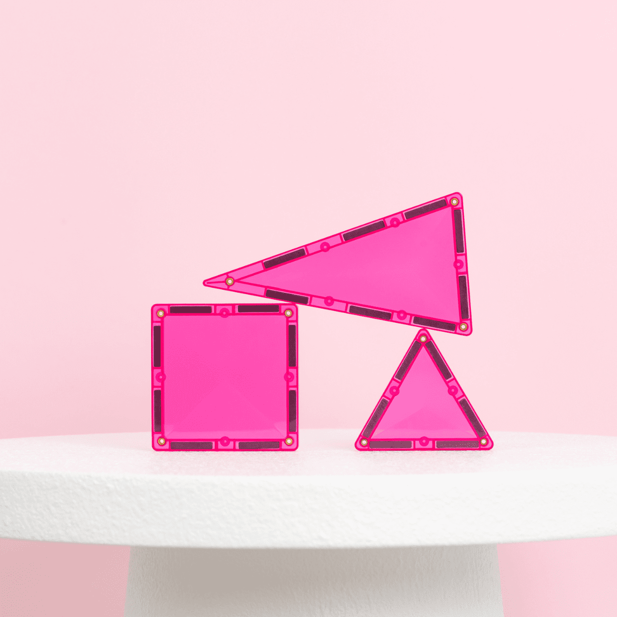 Three pink geometric frames on a gradient pink and white background