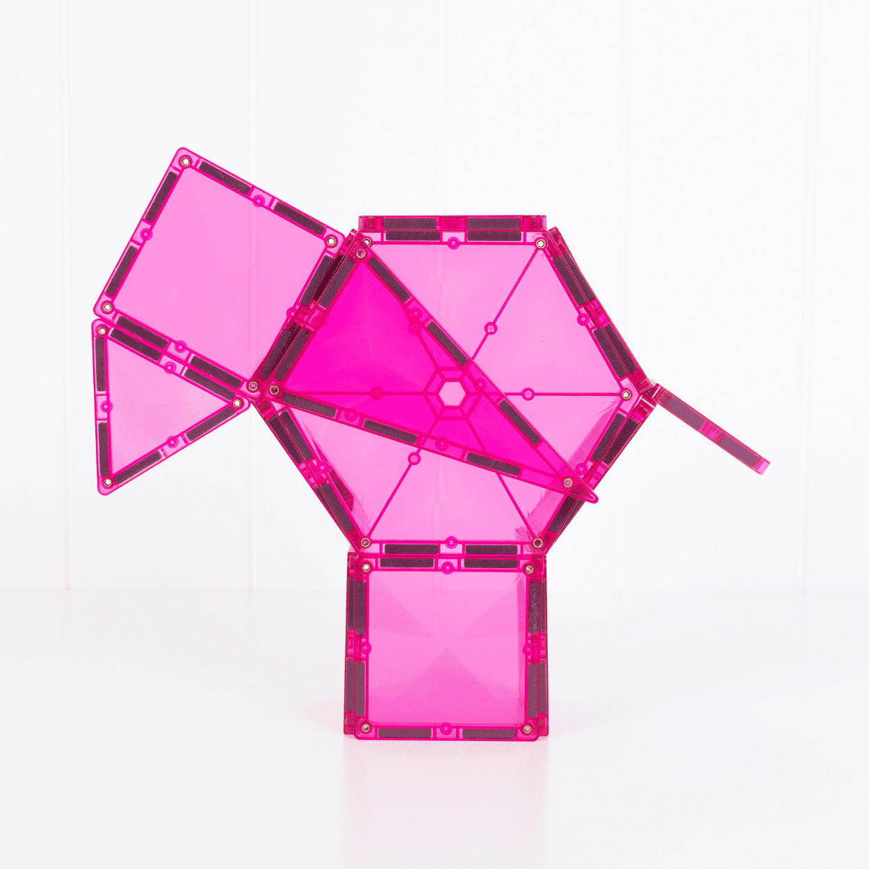 Pink geometric building block set on a white background
