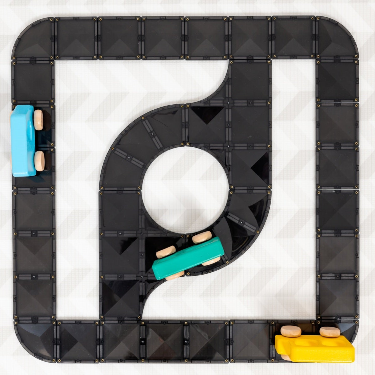 Black magnetic tiles with wooden cars