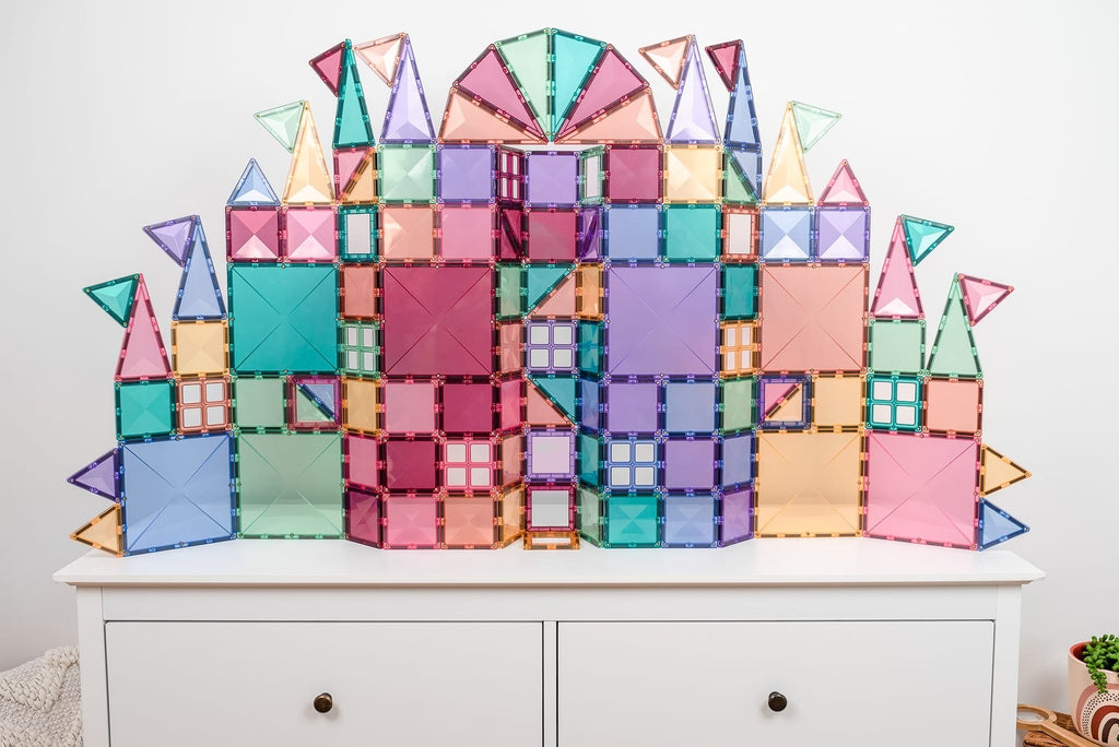 Colorful geometric castle model on a white dresser against a light gray wall