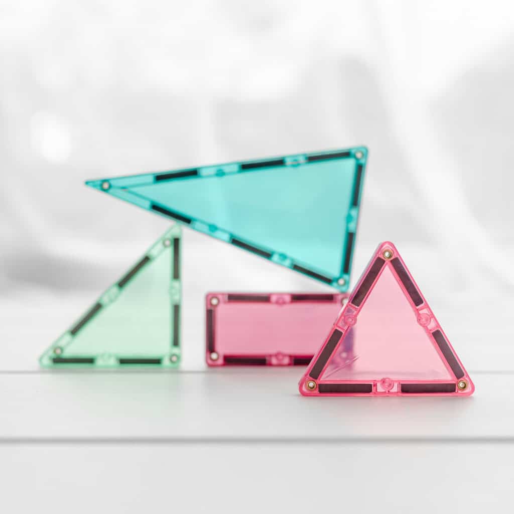 Four transparent triangular mirrors in green, pink, and red on a white background