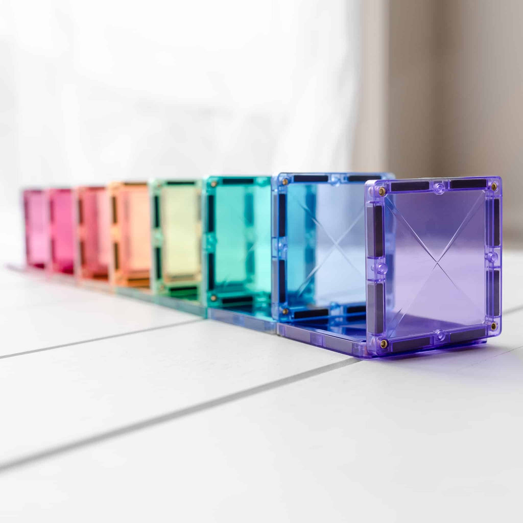 Row of colorful transparent cubes on a light surface