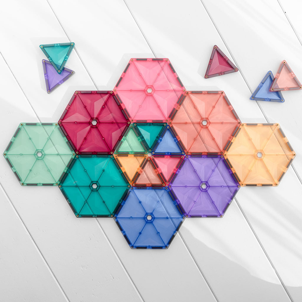 Colorful magnetic building blocks on a light wooden surface