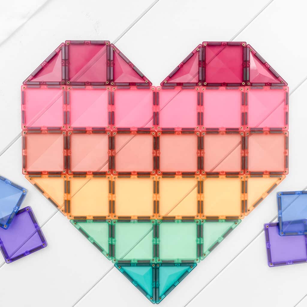 Colorful heart-shaped building block set on a white background
