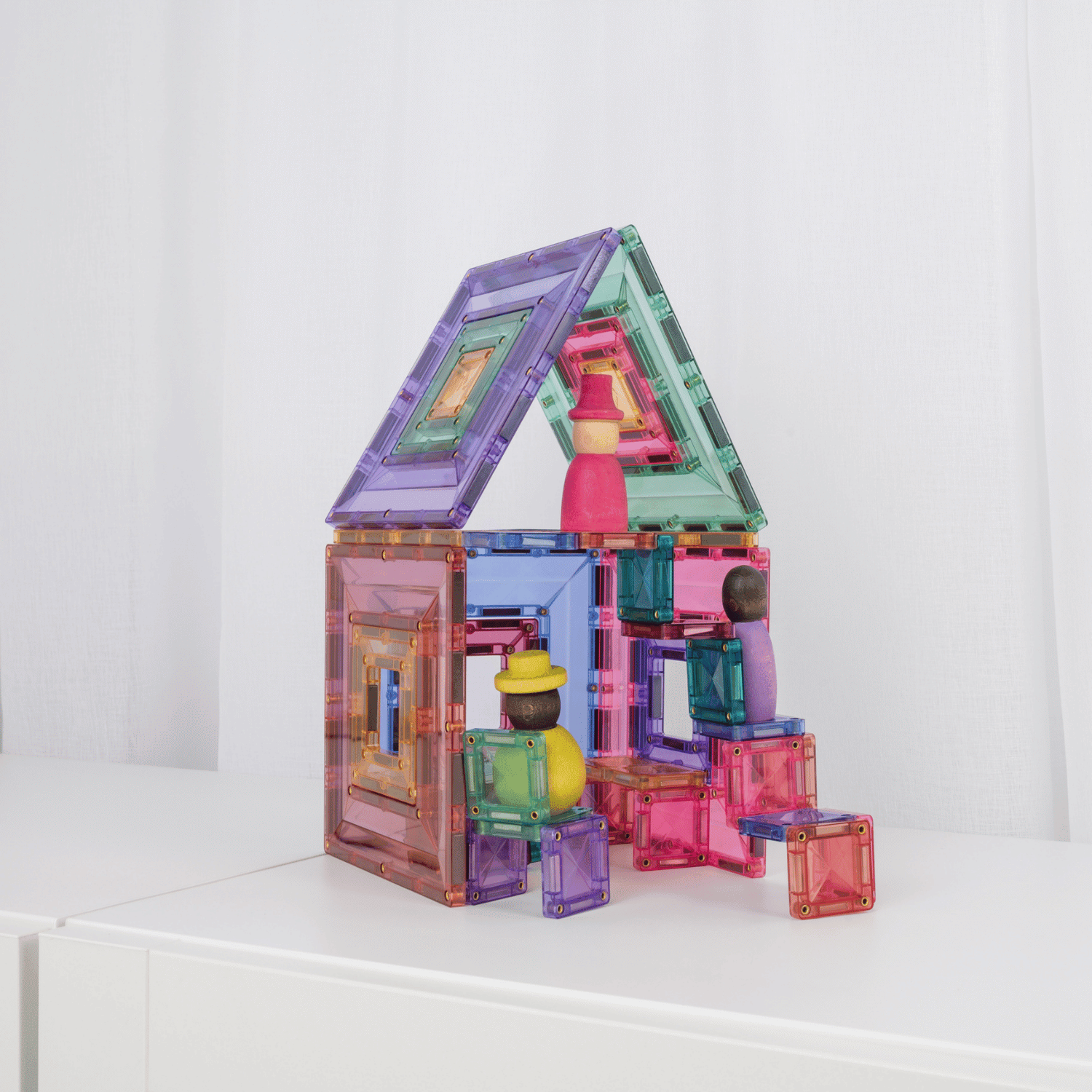 Colorful magnetic building blocks on a white surface