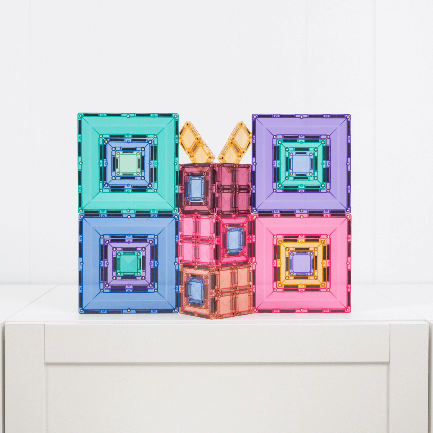 Colorful geometric building blocks on a white surface