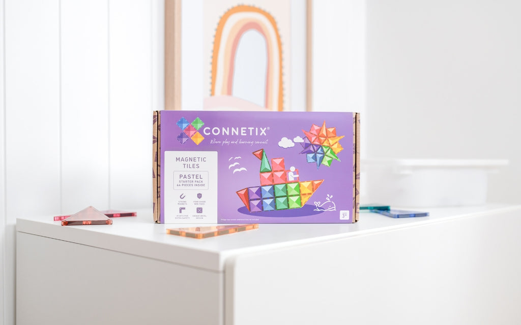 Connetix magnetic tiles packaging on a white surface with a white wall in the background
