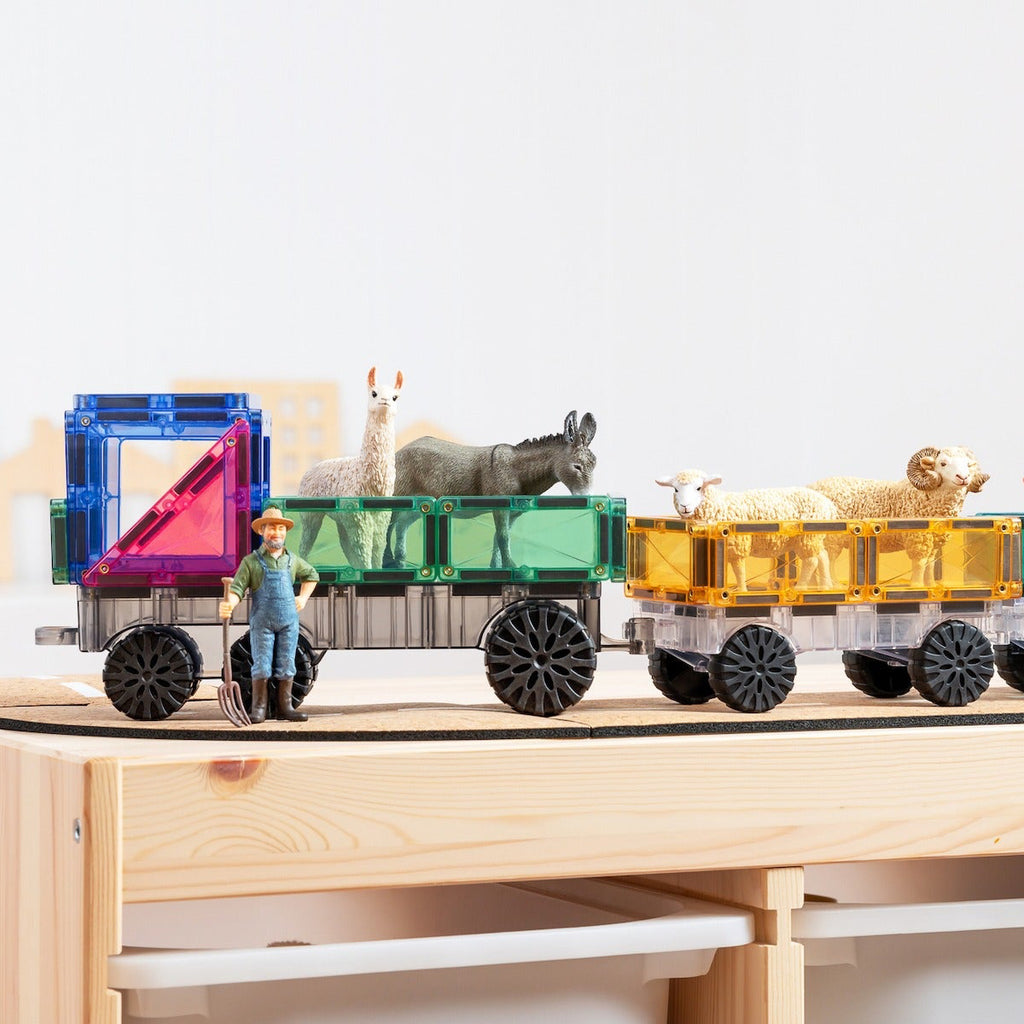 Toy train with colorful wagons and animals on a wooden platform