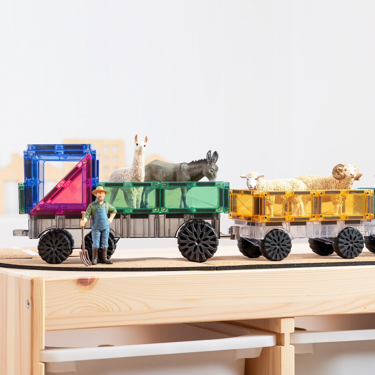 Toy train with colorful wagons and animals on a wooden platform
