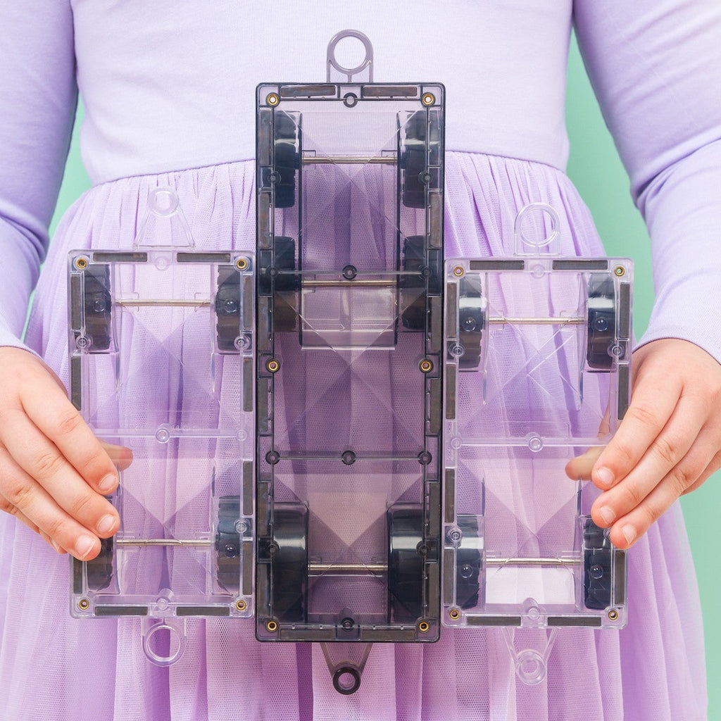 Person holding a transparent rectangular object against a light green background