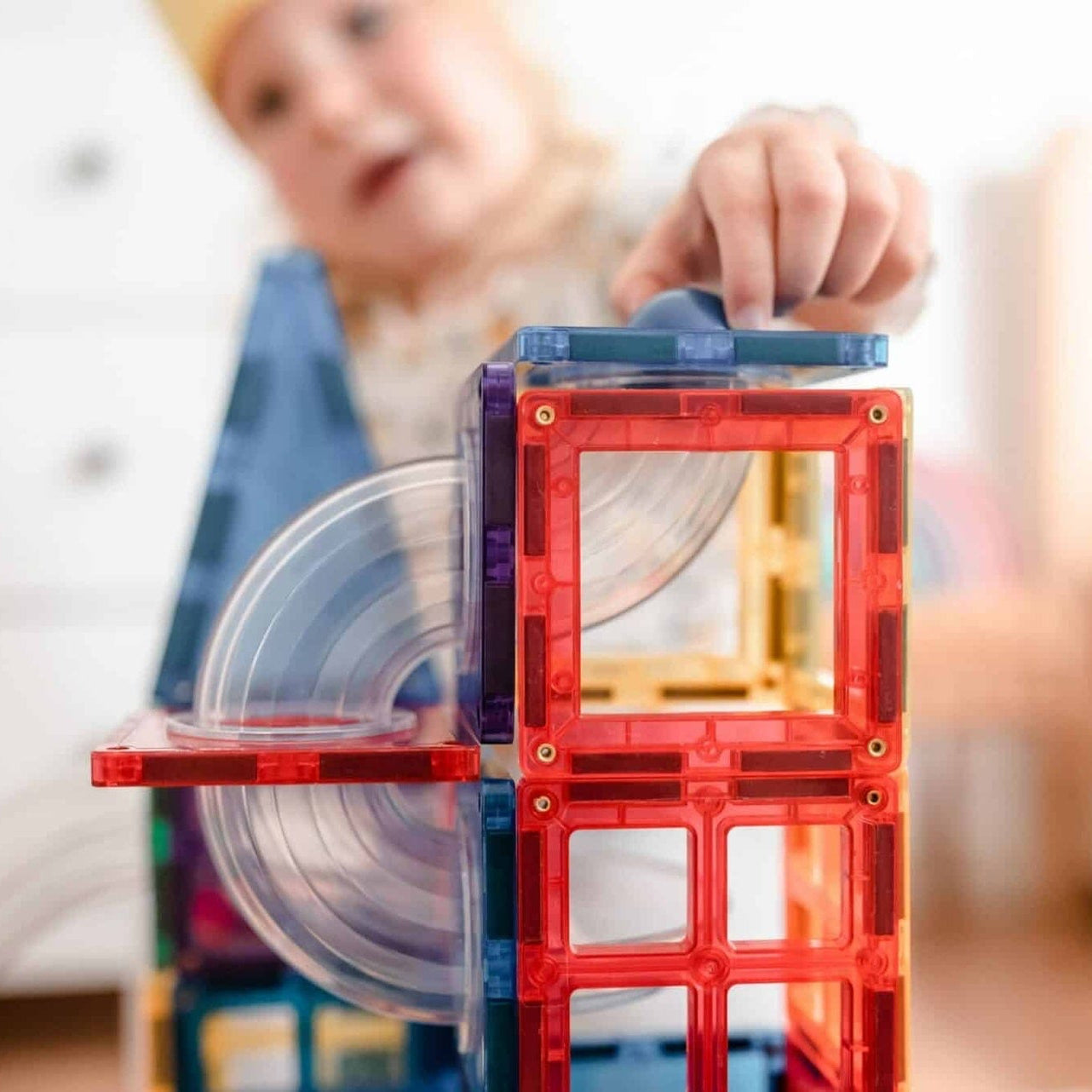 Child playing with colorful magnetic building blocks