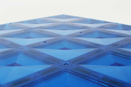 Blue geometric patterned surface on a white background