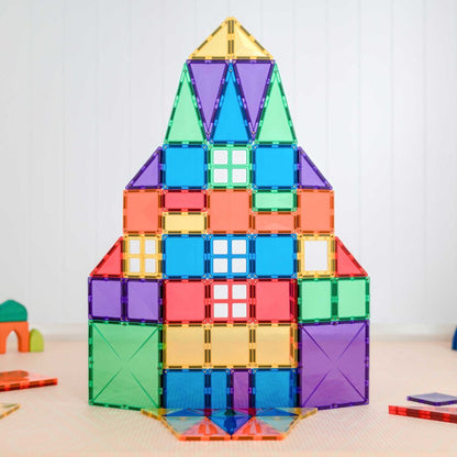 Colorful magnetic building block tower on a light surface with a white background