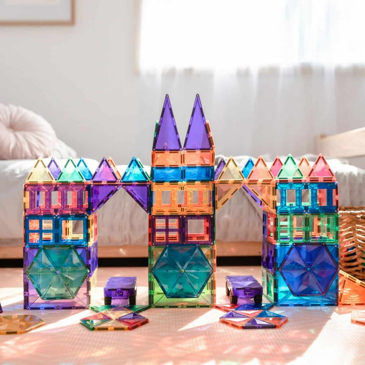 Colorful magnetic building blocks on a light wooden floor with a blurred background