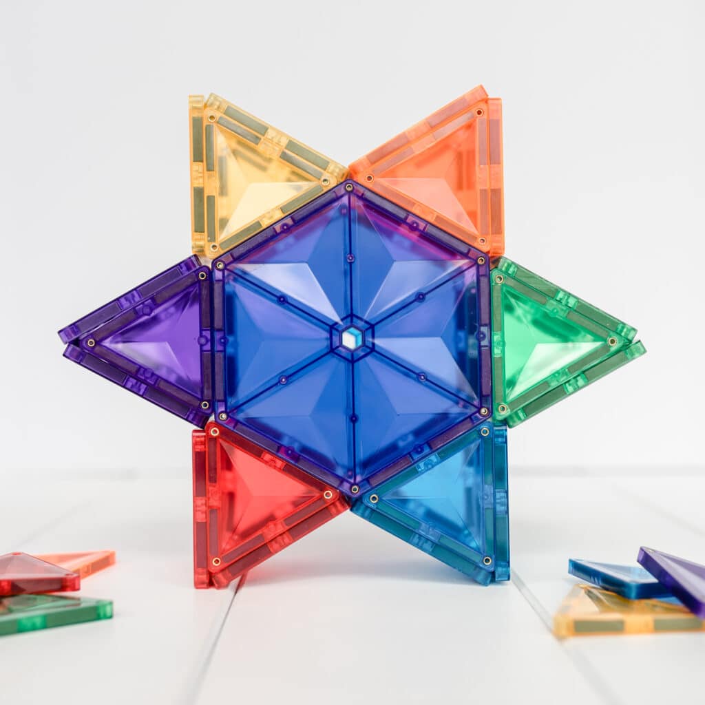 Colorful geometric transparent building blocks on a white background