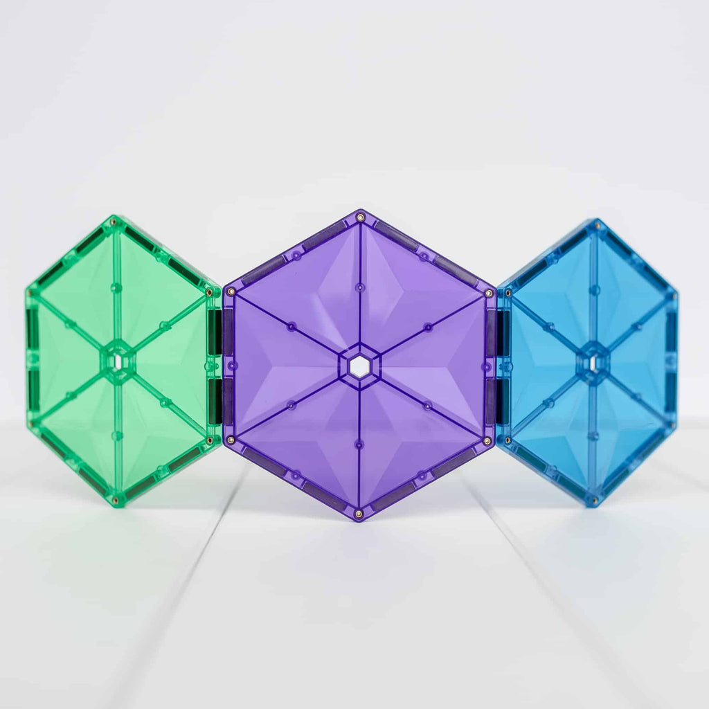 Three hexagonal building blocks in green, purple, and blue on a white background