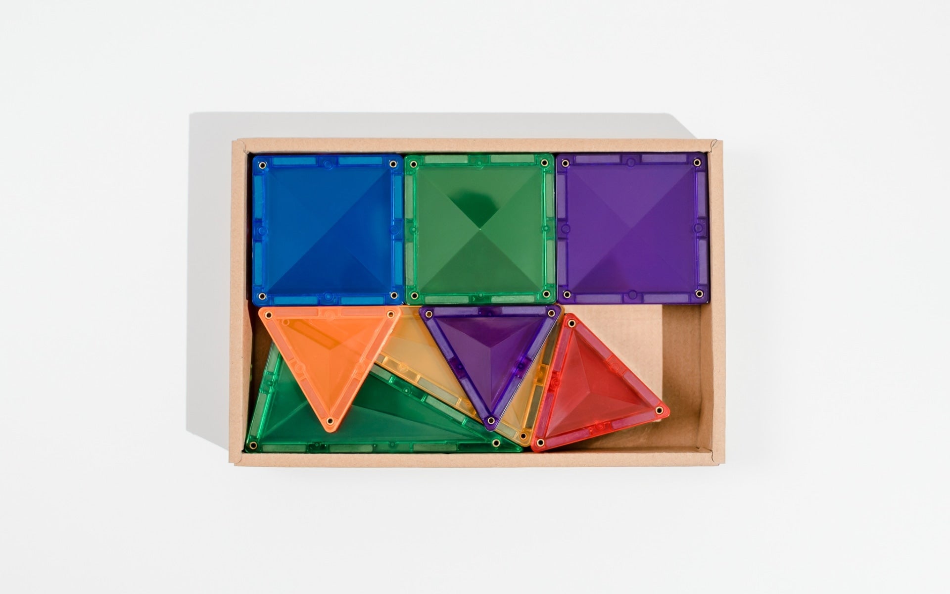 Colorful geometric building blocks in a  box on a white background