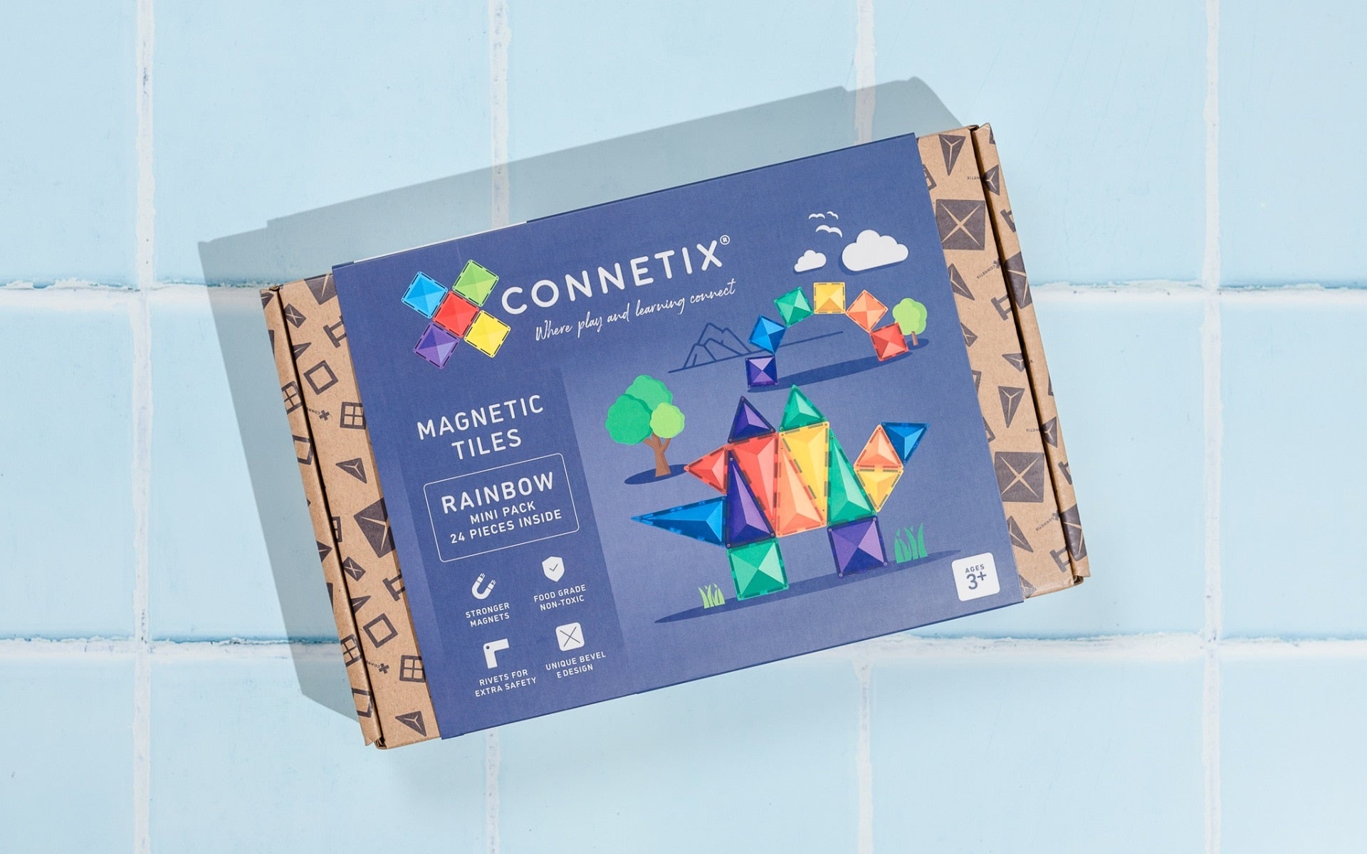 Connetix magnetic tiles packaging on a light blue tiled background