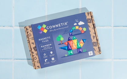 Connetix magnetic tiles packaging on a light blue tiled background