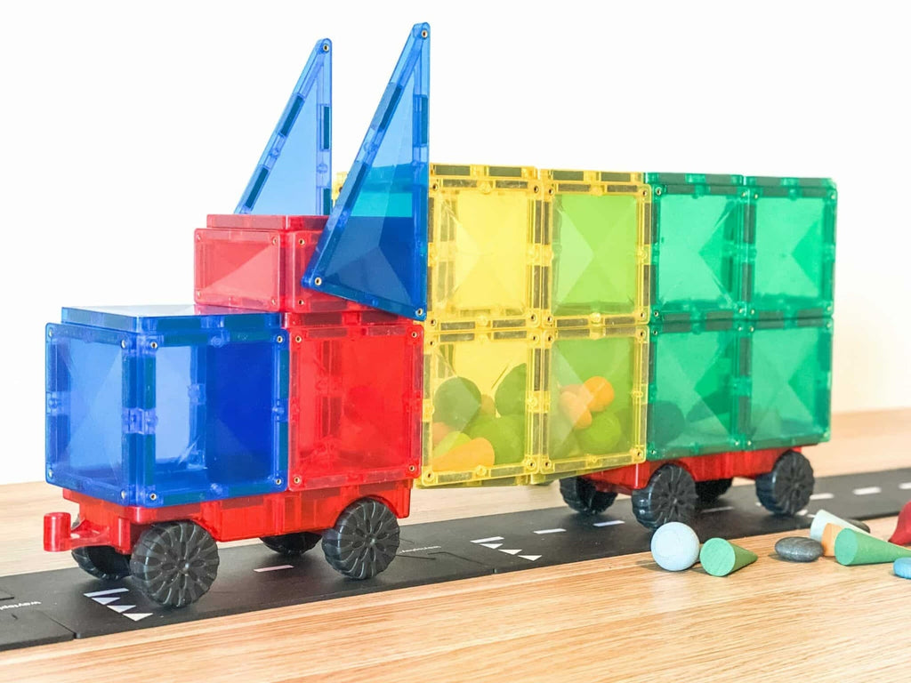 Colorful toy train set on a track with transparent containers